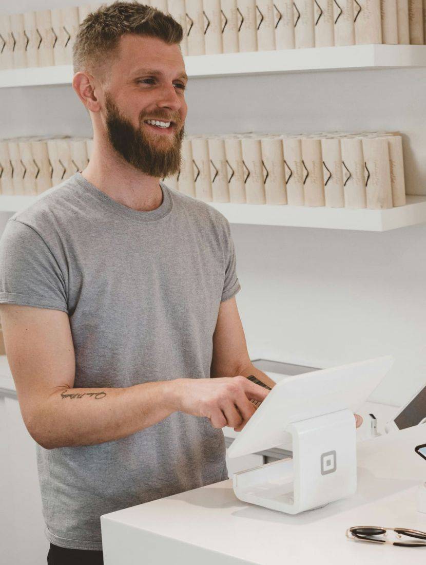 Commerçant souriant derrière son comptoir